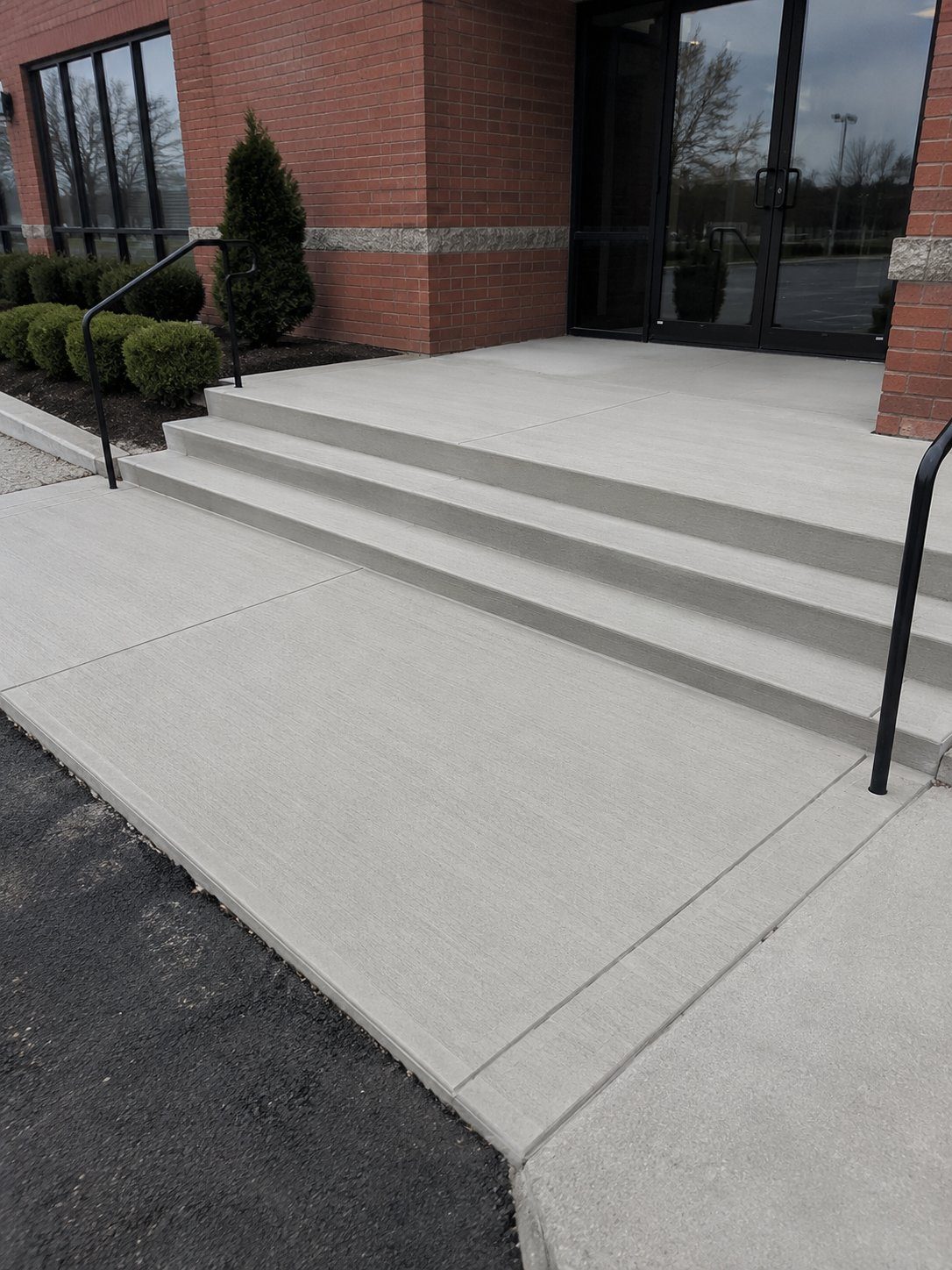 Commercial concrete entrance with steps and handrails in Novi, MI