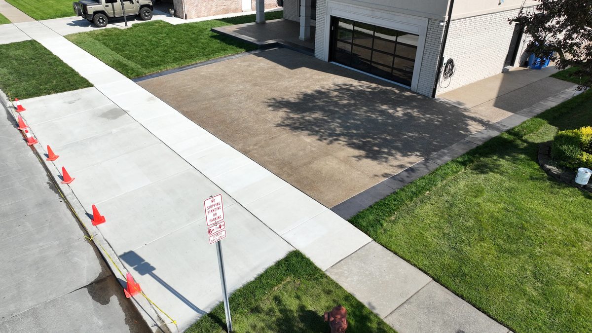 Exposed aggregate concrete driveway with charcoal border in Dearborn Heights, MI