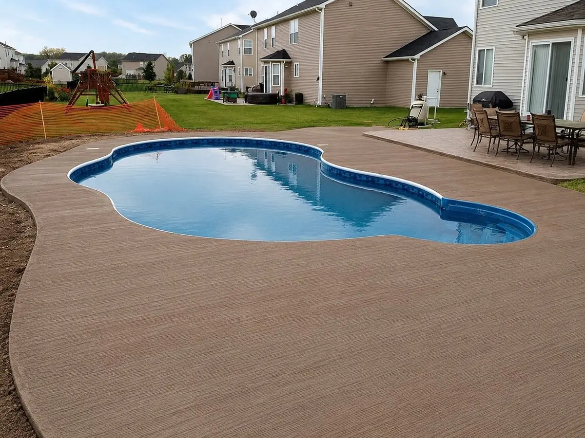 Colored broom finish concrete pool deck